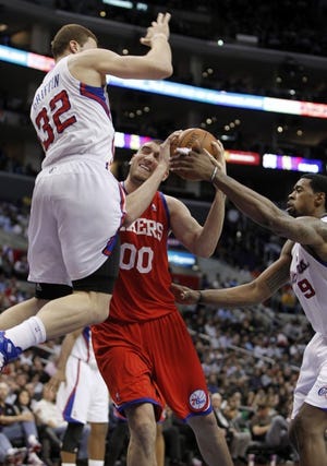 The Sixers' Spencer Hawes pump-fakes the Clippers' Blake Griffin into the air during Wednesday's 104-94 victory in Los Angeles. (AP Photo/Christine Cotter)