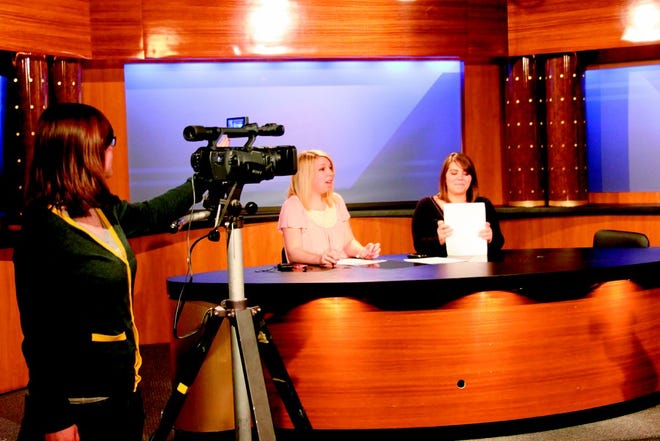 Katherine Young films MCTV news director Michelle Nutting and co-anchor Haleigh Turner during rehearsal Wednesday afternoon. The MCTV staff of about 10 students did their first broadcast with their new set, which was donated by the Quad Cities’ station WQAD, which recently switched over to a new HD set.