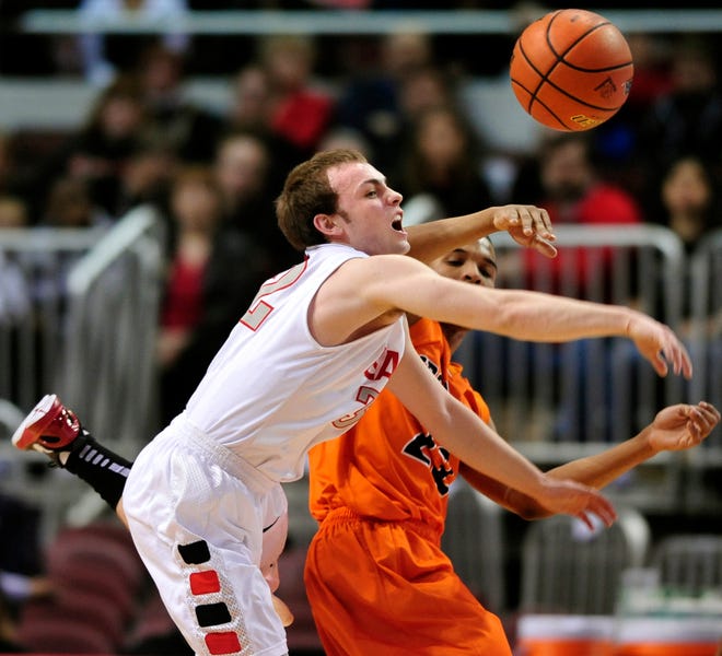 Zach Miller of Lombard Glenbard East knocks the ball away from Anthony Goodar of Normal Community, right, during Saturday's IHSA Class 4A consolation game at Carver Arena.