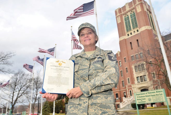 Master Sergeant Luann Van Peursem of Ogden, formerly of Farmington, with her Act of Courage medal certificate she received while in Iraq. She's pictured at the Canandaigua VA Medical Center on March 11, 2011.