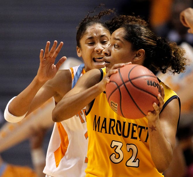Marquette's Angel Robinson is guarded by Tennessee's Meighan Simmons, who scored 18 points to help the Lady Volunteers reach the Sweet 16 in a narrow win.