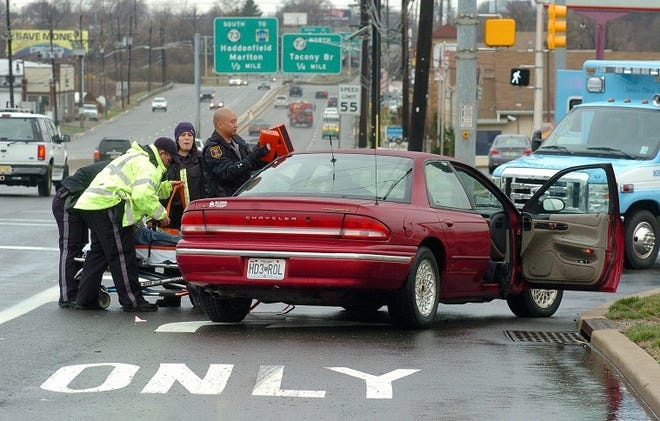 Cinnaminson police and emergency personnel tending to one of the dirvers involved in a three-car accident on Route 130 South at the Cinnaminson Avenue intersection on Monday afternoon. BCT Photo N.Rokos