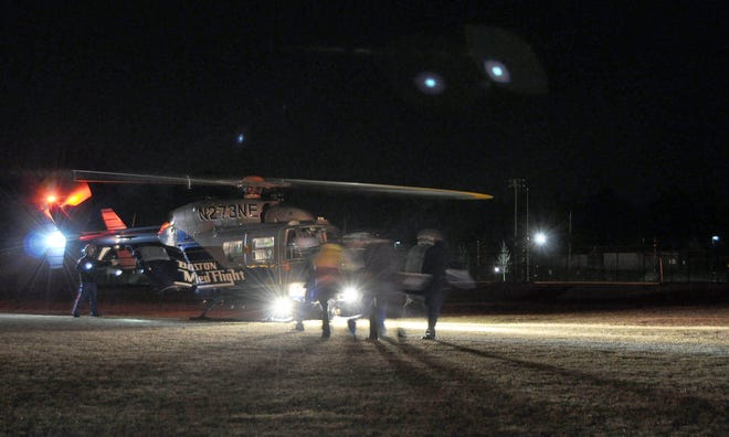 Emergency crews load a driver into a Medflight helicopter at Whitman-Hanson Regional High School on Sunday night. Firefighters said the driver crashed into a telephone pole near 272 Franklin St. about 7:40 p.m. Sunday, March 20, 2011.
