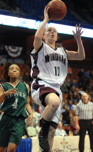 Windham's Carlee Smith, right, goes up for a basket as Weaver's Fifi Walcott, left, defends during the Class M basketball state championship at the Mohegan Sun Arena Saturday, March 19, 2011.
