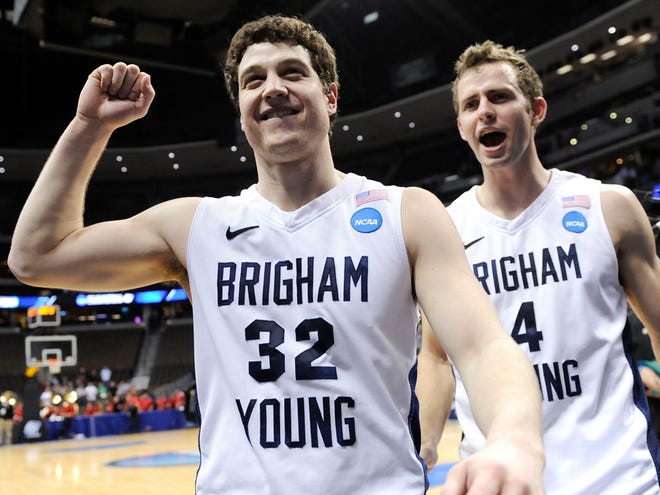 BYU's Jimmer Fredette, left, and Jackson Emery celebrate as they walk off the court after BYU defeated Gonzaga 89-67 in a Southeast regional third round NCAA tournament college basketball game, Saturday, March 19, 2011, in Denver. (AP Photo)