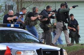 Heavily armed law enforcement officers storm a home in an Athens subdivision, thinking they might have suspect Jamie Hood cornered. The search came up empty.