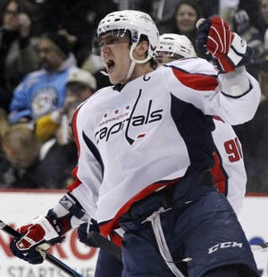 Washington Capitals' Alex Ovechkin (8), of Russia, celebrates his goal in the second period of an NHL hockey game against the Pittsburgh Penguins in Pittsburgh on Monday, Feb. 21, 2011. (AP Photo/Gene J. Puskar)