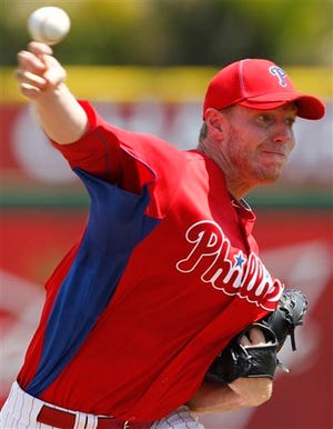 FILE PHOTO - Philadelphia Phillies pitcher Roy Halladay warms up before the first inning of a spring training baseball game against the Boston Red Sox in Clearwater, Fla., Monday, March 21, 2011. (AP Photo/Gene J. Puskar)