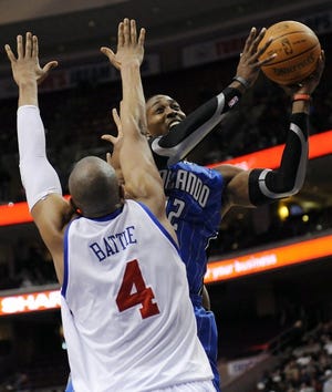 The Magic's Dwight Howard shoots over the Sixers' Tony Battie during Orlando's 99-95 victory Feb. 9 at the Wells Fargo Center. (AP Photo/Michael Perez)