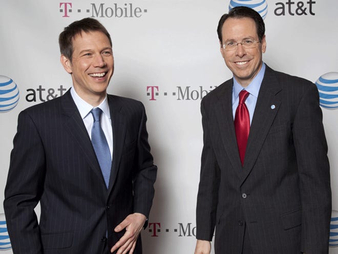 Deutsche Telekom Chairman and CEO Rene Obermann, left, and AT&T Chairman and CEO Randall Stephenson pose for photos in New York. AT&T Inc. said Sunday it will buy T-Mobile USA from Deutsche Telekom AG in a cash-and-stock deal valued at $39 billion that would make it the largest cellphone company in the U.S.