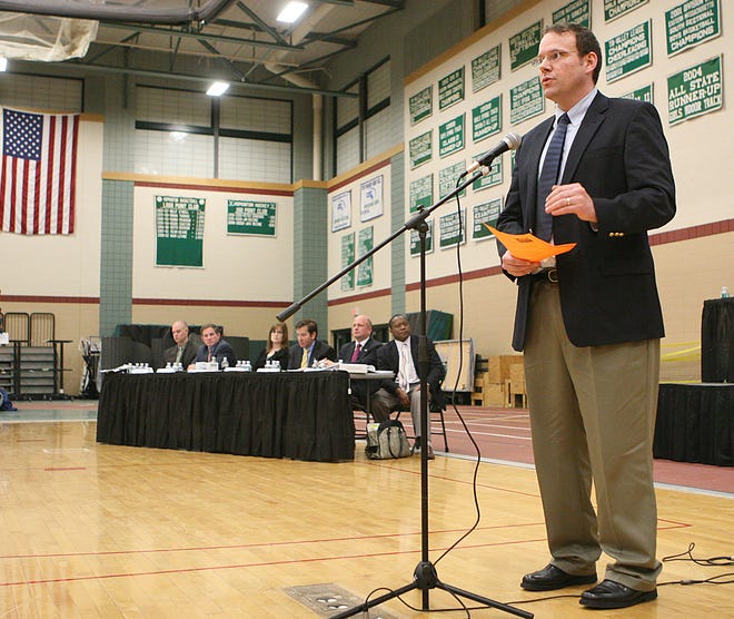 Hopkinton resident Glen Layton speaks at special Town Meeting last night at Hopkinton High School. He represented a group of voters who were against building a new school on Fruit Street in Hopkinton.