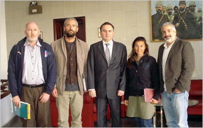 Levent Sahinkaya, center, the Turkish ambassador to Libya, at the Turkish Embassy in Tripoli, Libya, with the four freed New York Times journalists: from left, Stephen Farrell, Tyler Hicks, Lynsey Addario and Anthony Shadid.
