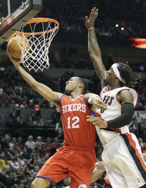 The 76ers' Evan Turner lays the ball up as the Portland Trail Blazers' Gerald Wallace defends in the first quarter of Saturday's game in Portland. (AP Photo/Rick Bowmer)