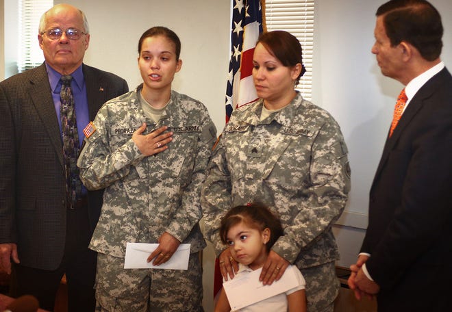 SPC/E4 Jessica Pedraza, left, and her mother Sgt. Marilyn Gonzalez, National Guard veterans who served together in Iraq and Kuwait, were awarded welcome home bonuses by State Treasurer Steve Grossman, right, on Wednesday, March 23, at Rockland Town Hall. Rockland Veterans Agent Tony Materno is at left, Gonzalez daughter, Brooklyn, is in center. 
Gary Higgins/The Patriot Ledger