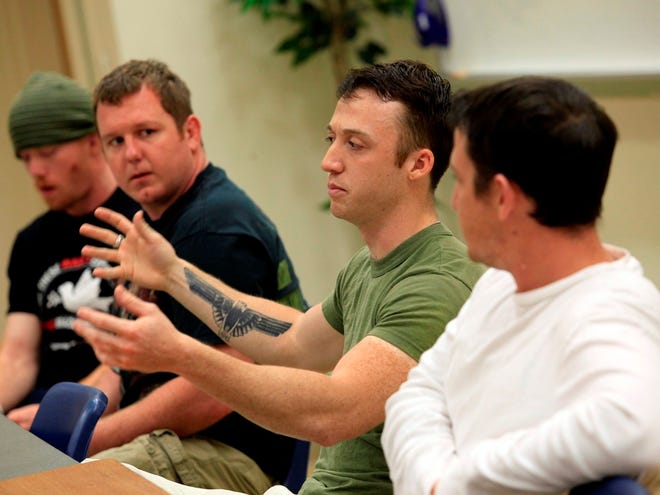 Marine veterans, from left, Mark DeFord, Michael McKenna, Wyatt Zinninger and Zachary Sizemore speak about their experiences during a “Veterans Speak Out” session at Santa Fe College on Wednesday in Gainesville.