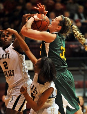 Arbishop Wood defeats Prep Charter 41-27 in the semifinals of the girls AAA state tournament at St. Joseph's University. Archbishop Wood's Victoria Arngo is fouled as she drives between Prep Charter's Nydeera Lee (left) and Yasmine Montgomery (right) during the second quarter.

- Steve Gengler / Staff Photographer