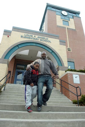 Julio Momblaisir of Brockton and his son Christopher, 7, leave the Angelo School on Wednesday, a day after a Stonehill College tutor was charged with child rape of a third-grade girl.