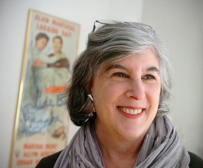 Author Hallie Ephron stands in font of an original poster advertising a 1940s-era movie for which her parents, Henry and Phoebe Ephron, were the screenwriters.