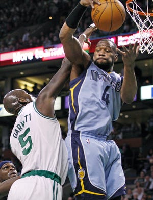 Memphis Grizzlies guard Sam Young (4) rebounds the ball over Boston Celtics forward Kevin Garnett (5) during the first quarter of an NBA basketball game in Boston on Wednesday, March 23, 2011.
