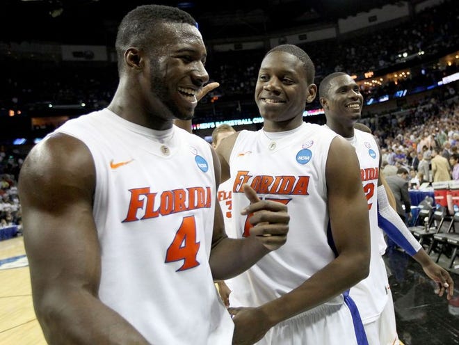 Florida's Patric Young, left, and Will Yeguete celebrate after beating the BYU Cougars in overtime of their NCAA Tournament regional semifinal game at the New Orleans Arena on Thursday, March 24, 2011. The Gators defeated BYU, 84-73, to advance to the Elite Eight.