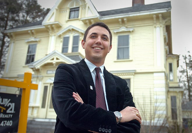 Realtor Ryan Glass stands in front of an 1870 Victorian in Holbrook, which has been on the market since December. The house is listed at $429,000. The central staircase of the 4,600-square-foot Victorian for sale in Holbrook.