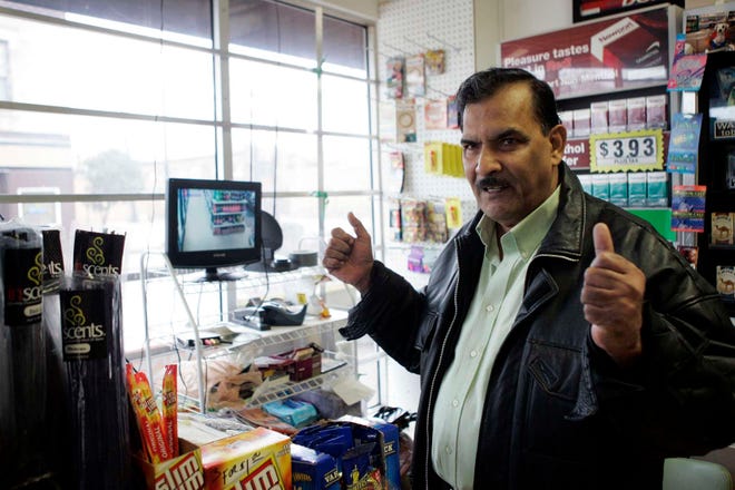 Azeem Uddin, manager of Discount Mart, talks about the added security that comes from having bars on his windows Wednesday, March 23, 2011, at his shop at the corner of Ninth Street and Broadway in Rockford.