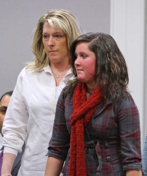 Jaimie Cates, right, arrives in court on Friday.