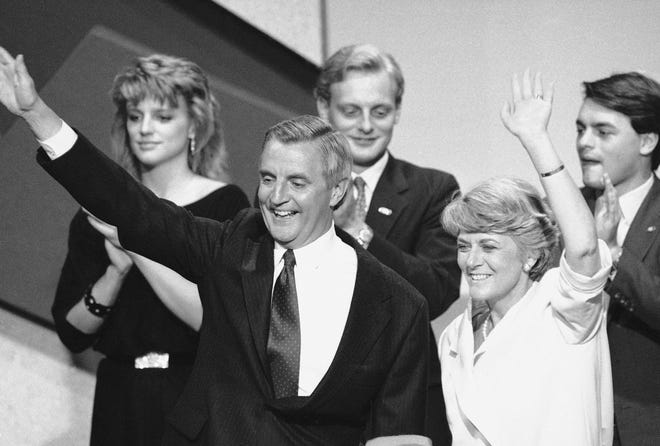 Democratic presidential nominee Walter Mondale, center, and his running mate Geraldine Ferraro, right, wave from the podium at the 1984 Democratic National Convention. In background are Mondale's children, from left, Eleanor, Ted and William.