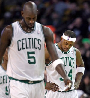 Boston Celtics Kevin Garnett (5) and teammate Paul Pierce (34) walk upcourt after a timeout in the second half of an NBA basketball game against the Los Angeles Clippers in Boston on Wednesday, March 9, 2011. The Clippers won 108-103. (AP Photo/Elise Amendola)
