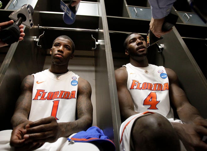 Florida's Kenny Boynton (1) and Patric Young (4) react in the locker room after losing to Butler on Saturday in the NCAA Southeast Regional semifinal.