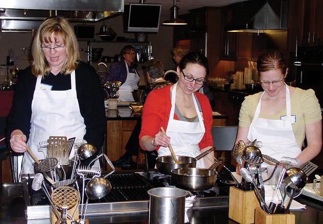 Lisa Hochreiter, of Edgewood Lane in Bergen, Stephanie Snow, of Laureldale Drive in Pittsford and Jeanne Schriel, of Ottawa, Canada making a maple sauce for their maple walnut baklava during a Baking with Maple Hands-On Kitchen class at the New York Wine Culinary Center Sunday afternoon.