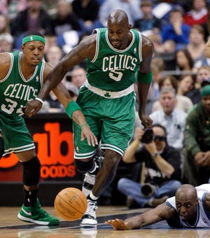 Boston Celtics forward Kevin Garnett (5) goes for the loose ball along with teammate Paul Pierce (34) and Minnesota Timberwolves center Anthony Tolliver during the first half of an NBA basketball game Sunday, March 27, 2011, in Minneapolis. (AP Photo/Paul Battaglia)