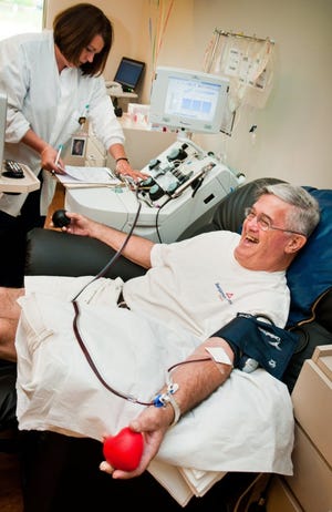 ill Conroy laughs as he donates platelets as the first 100-gallon donor for The Blood Alliance in Orange Park. He believes if you give to charity, you will receive tenfold in return.