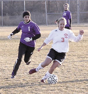 Hayley Baker moves the ball up the field while Three Rivers’ Jessica Mathews defends on Monday.
