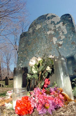 Flowers and candles were left at the grave of Hannah Arnold, wife of Captain Benedict Arnold Monday at at the Old Norwichtown Burial Ground.
