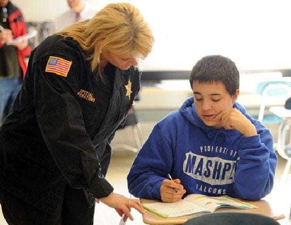 Barnstable County Sheriff’s Deputy Kimberly Saladino works on an exercise with Mashpee Middle School student Moises Barros, 13, on Monday .
Tuesday