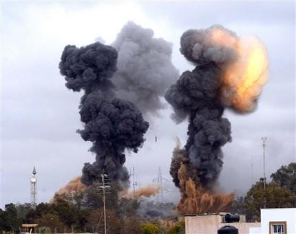 In this photo released by China's Xinhua news agency, heavy smoke rises over the Tajoura area, some 30 km east of Tripoli, Libya, after an airstrike on Tuesday March 29, 2011.