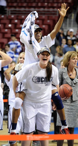 Connecticut center Stefanie Dolson and guard Tiffany Hayes, top, celebrate after defeating Duke 75-40 in an NCAA women's college basketball tournament regional final game, Tuesday, March 29, 2011, in Philadelphia. (AP Photo/Barbara Johnston)