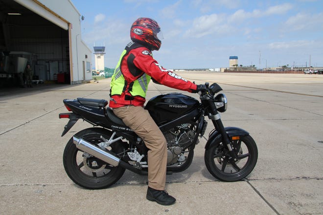 Larry DeLong, Naval Station Mayport Safety Specialist models the correct PPE (personal protection equipment) while riding a trainer motorcycle at the C-12 Hangar prior to a motorcycle safety class.