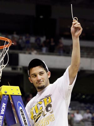 Virginia Commonwealth point guard Joey Rodriguez displays a piece of the net after the Rams won the Southwest Regional by beating top-seeded Kansas, 71-61, on Sunday in San Antonio.