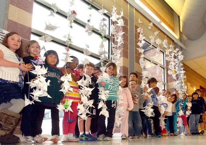 Standing proudly next to a section of the 1,000 crafted paper cranes they made are third grade students from Michael Potter's calss at the Chairville School in Medford, Thursday afternoon. The project was a fundraiser for the victims of Japan's earthquake and tsunami. BCT Photo N.Rokos