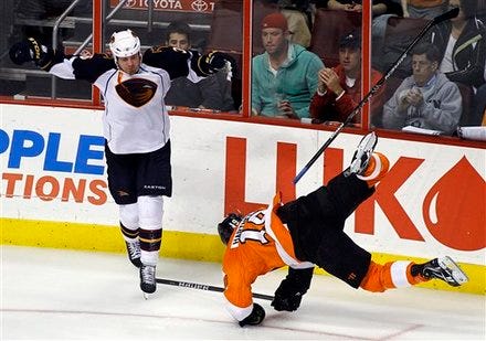 Atlanta Thrashers' Eric Boulton, left, loses his stick as Philadelphia Flyers' Scott Hartnell goes down after colliding in the third period of an NHL hockey game, Thursday, March 31, 2011, in Philadelphia. The Thrashers won 1-0. (AP Photo/Tom Mihalek)