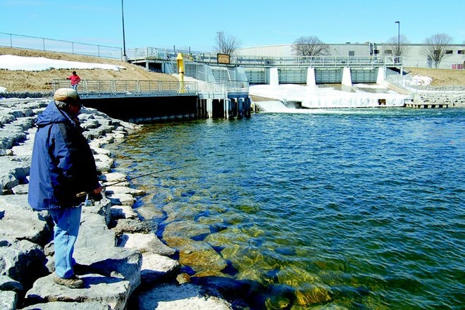 Don Stokes wets a line hoping for a little Steelhead action at the plunge pool below the Cheboygan River Dam on a sunny Wednesday afternoon.