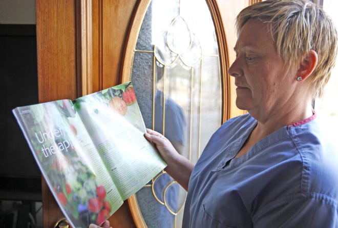 Laurie Anne McGeever looks over the story she wrote, "Under the Apple Tree," that was published in a recent edition of Nursing 2011.