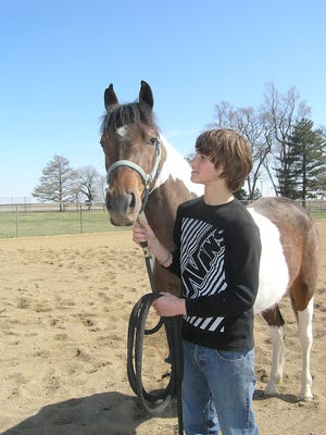 Matt Maccani, 16, of Racine, Wis., above, said his favorite part of the ranch is working with the horses. He is shown with Painted Psychia, a paint horse. At right, Maccani works with Painted Psychia, getting ready for the April 9 annual Charity Auction and Horse Sale at the ranch now called Salem 4 Youth.