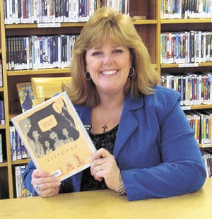 Perri Saunders, director of the White Pigeon Township Library holds a copy of “Stitches,” the selected book for this year’s “One Book, One County” program.