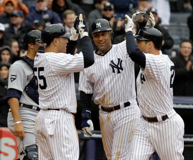 New York Yankees Russell Martin, (55) and Derek Jeter, center, greet Mark Teixeira after Teixeira's, third inning three-run home run in their opening day baseball game against the Detroit Tigers at Yankee Stadium on Thursday, March 31, 2011 in New York. Tigers catcher Alex Avila is at left. (AP Photo/Kathy Willens)