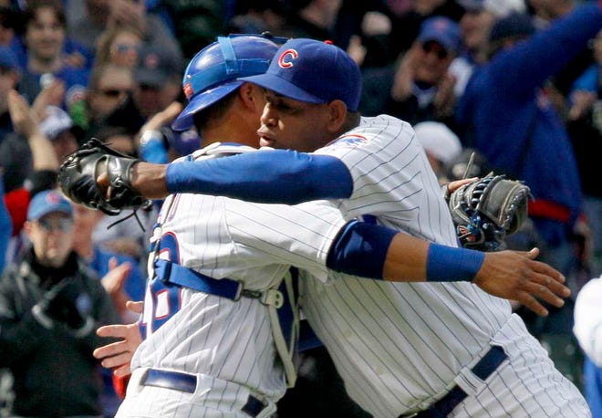 Chicago Cubs catcher Geovany Soto celebrates with relief pitcher Carlos Marmol after their 5-3 win over the Pittsburgh Pirates on Saturday, April 2, 2011, in Chicago. Marmol earned his first save of the season.
