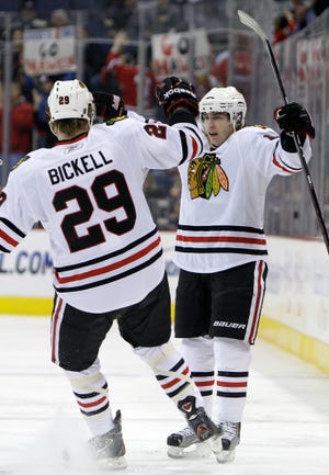 Chicago Blackhawks' Patrick Kane, right, celebrates his goal against the Columbus Blue Jackets with teammate Bryan Bickell during the first period of an NHL hockey game on Friday, April 1, 2011, in Columbus, Ohio.