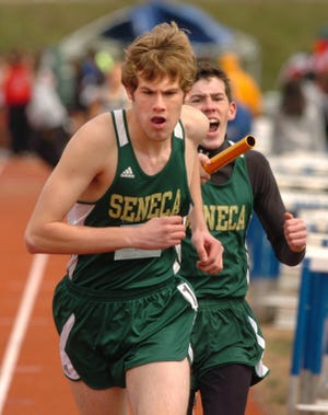 Third-leg runner Ed Bohi yells to teammate Ian Grant, Seneca's anchorman, as Bohi prepares to hand off the baton during the distance medley race at the Hall of Fame Relays. Seneca won the large school race.